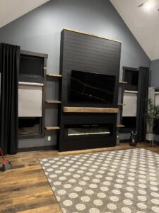 A custom-built modern media center and fireplace unit, creating a focal point in a living room by Midwest Home Remodeling & Design LLC in Chicago, IL.