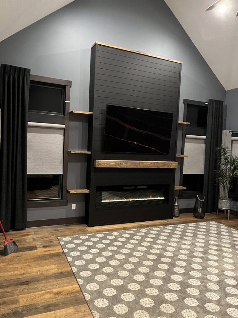 A custom-built modern media center and fireplace unit, creating a focal point in a living room by Midwest Home Remodeling & Design LLC in Chicago, IL.