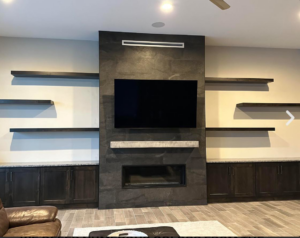 Custom media wall with fireplace, built-in cabinets, and floating shelves by Arizona Cabinet & Countertop Company in Tucson, AZ.