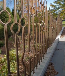 A beautifully crafted custom metal fence installed outdoors by Bighorn Forge, Inc. in Kewaskum, WI, showcasing expert fabrication.