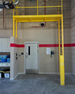 A custom yellow metal platform and ladder structure installed by Chavez Wrought Iron, LLC in Tucson, AZ