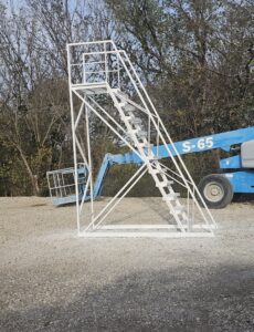 A custom white metal staircase and platform being installed, showcasing work by M.M. Remodelers in Resaca, GA.