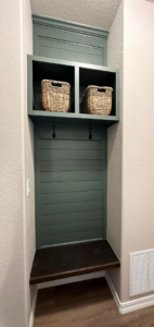 A custom-built mudroom bench with storage cubbies and hooks by RK Pro Service Inc in Colorado Springs, CO.