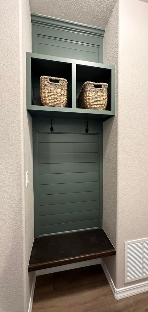 A custom-built mudroom bench with storage cubbies and hooks by RK Pro Service Inc in Colorado Springs, CO.