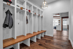 A custom-built mudroom with white cubbies and a wooden bench, expertly crafted by Bob Build's WNY in Buffalo, NY.