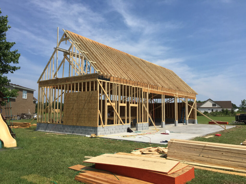 A custom-built outdoor kitchen and patio area with a covered pergola, created by RMG Construction in Chesapeake, VA.