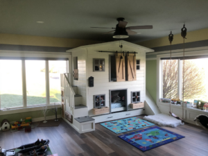A custom-built playhouse and bunk bed structure in a child's room by Grabill Painting and Drywall in Fort Wayne, IN.