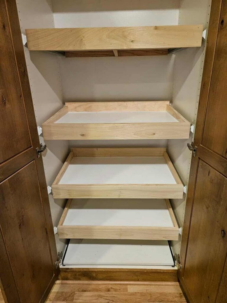 Custom pull-out shelves installed in a cabinet, a carpentry service by Honeycomb Handyman Services in Salt Lake City, UT.