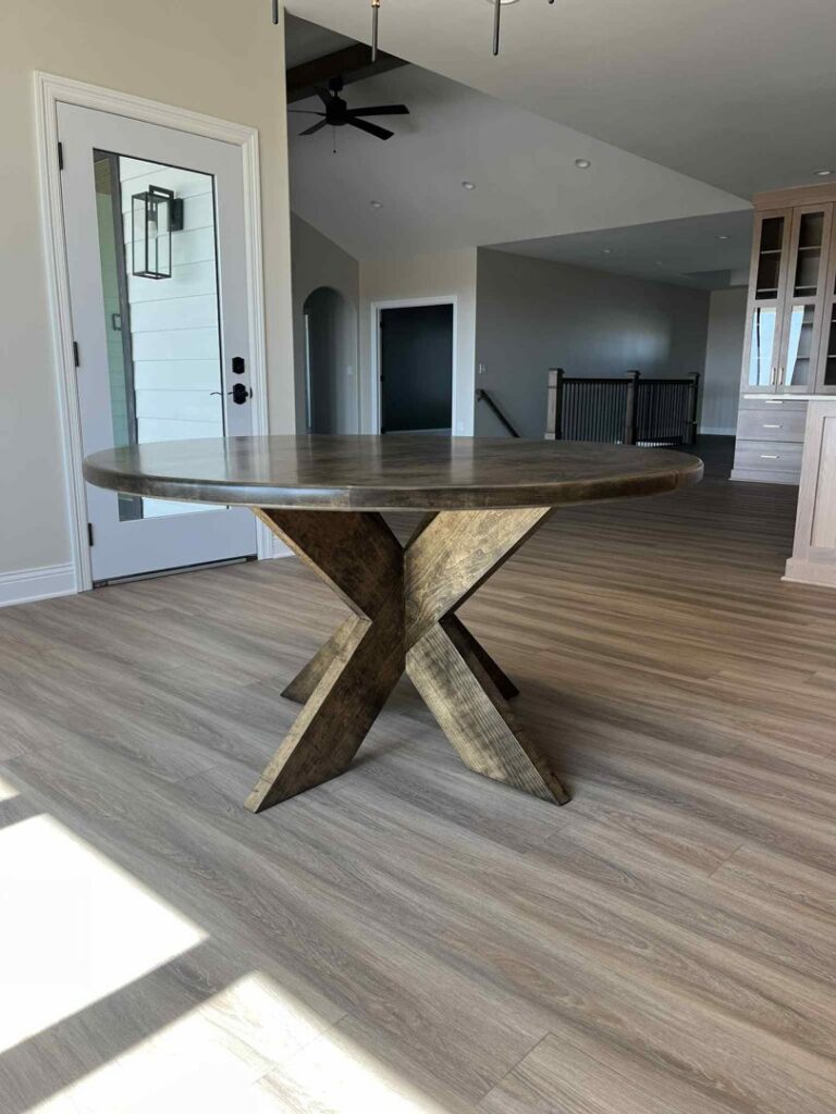 A custom round dining table with a unique wooden base crafted by Renegade Woodworks in Kearney, NE.
