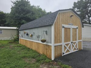 Custom built shed with new siding and barn doors by A Man Who Can LLC, your handyman in Milford, DE.