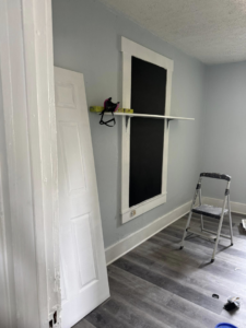Custom shelf installation and door hanging in a room under renovation by JW Contracting Services, LLC in Dayton, OH.