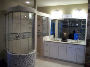 A luxurious bathroom featuring a custom shower enclosure and double vanity installed by Cohaco Building Specialties in Peoria, AZ.