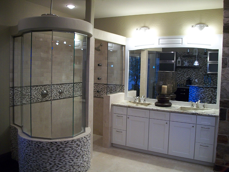 A luxurious bathroom featuring a custom shower enclosure and double vanity installed by Cohaco Building Specialties in Peoria, AZ.