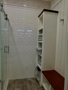 Custom shower area with subway tiles, glass door, built-in bench, and shelving by Lardieri's Custom Woodworking Company, Inc. in Lakewood, NJ.
