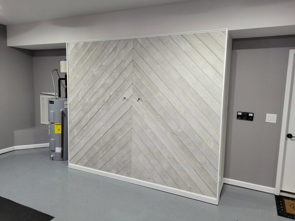 A custom sliding wall system in a garage, providing hidden storage solutions, completed by Huff Consolidated Enterprises LLC in Clarksville, TN.