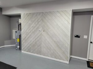 A custom sliding wall system in a garage, providing hidden storage solutions, completed by Huff Consolidated Enterprises LLC in Clarksville, TN.