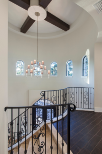 A custom staircase installation with elegant wrought iron railings by Cornerstone Custom Construction LLC in Beaver Falls, PA