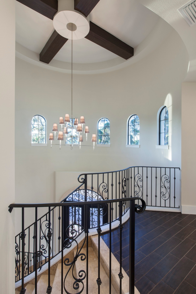 A custom staircase installation with elegant wrought iron railings by Cornerstone Custom Construction LLC in Beaver Falls, PA