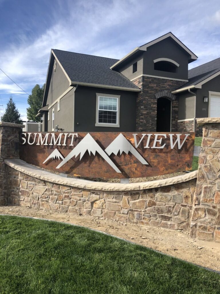 A custom stone and metal 'Summit View' sign installation completed by Summit Crest Construction, LLC in Yakima, WA.