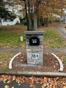 A custom stone mailbox pillar with house number 784 installed by Tomori's masonry llc in Cheshire, CT