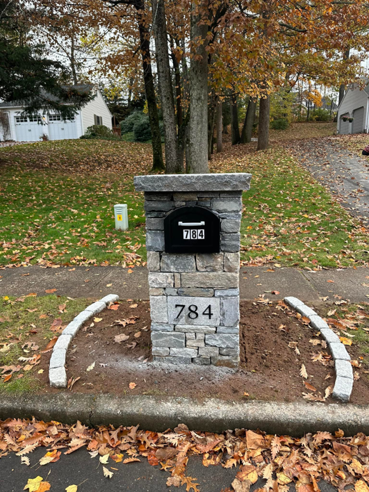 A custom stone mailbox pillar with house number 784 installed by Tomori's masonry llc in Cheshire, CT