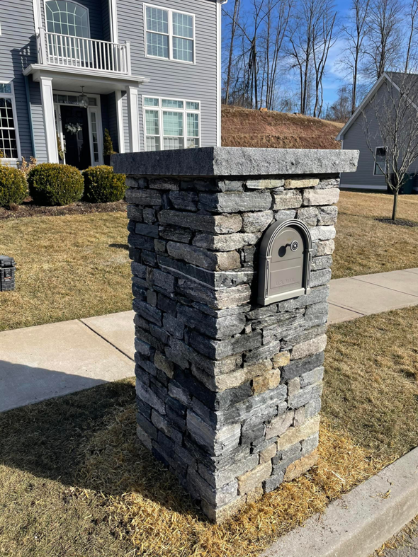 A custom stone mailbox post installed by Tomori's masonry llc in Cheshire, CT