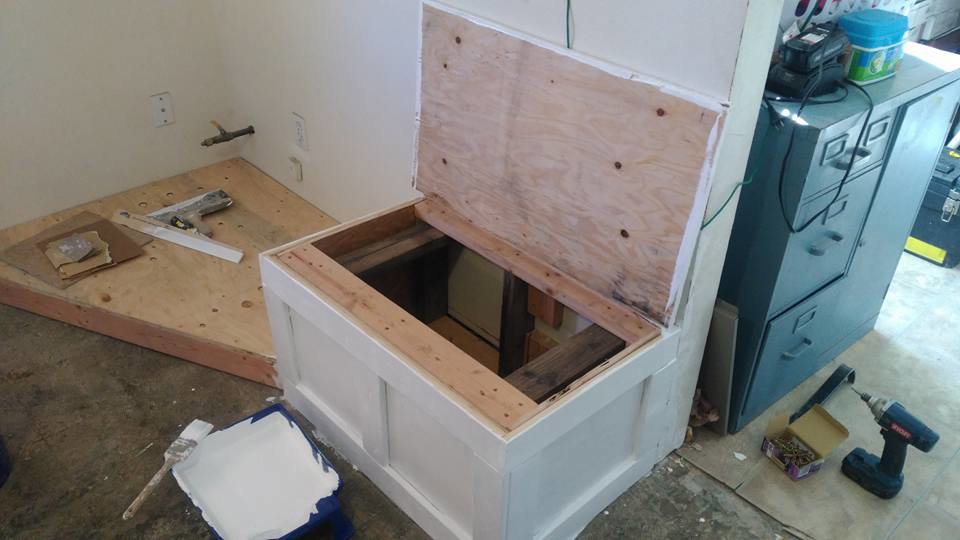 A custom wooden storage bench under construction, with its lid open, showing handyman carpentry work by MG'S Services LLC in Albuquerque, NM.