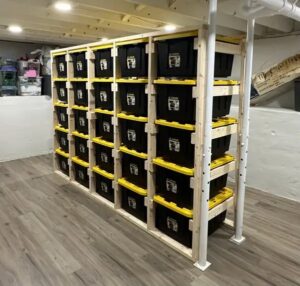 A custom-built wooden shelving unit for storage bins by Profix Home Repair in Jonesboro, AR.