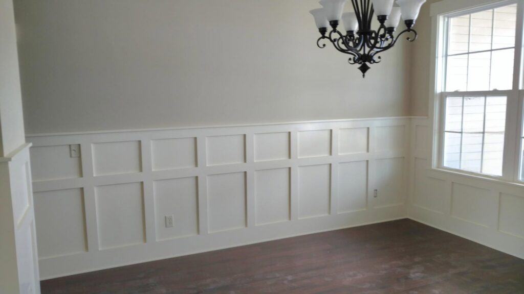Custom wainscoting installed on a wall in a room by Majestic Homes FW in Fort Wayne, IN.