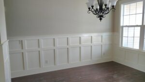 Custom wainscoting installed on a wall in a room by Majestic Homes FW in Fort Wayne, IN.