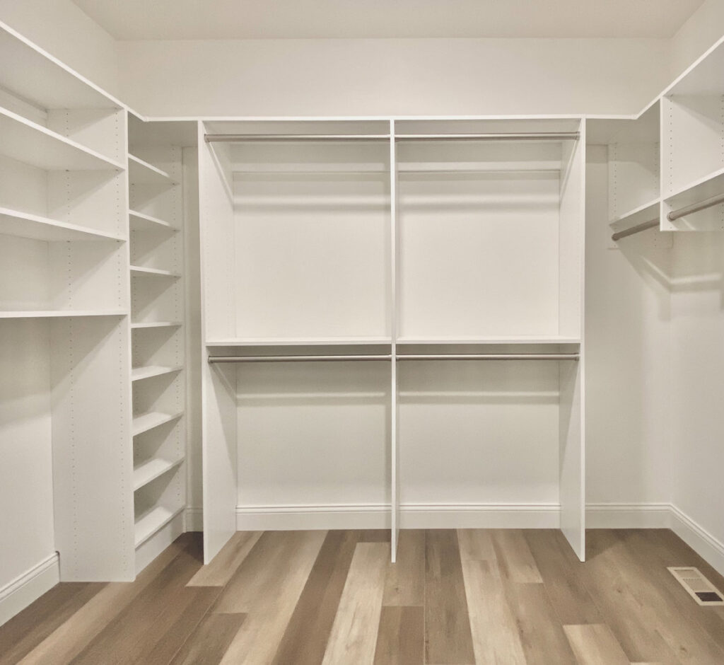 Custom walk-in closet with new shelving and hanging rods installed by Rave Homes - Missouri in Columbia, MO.