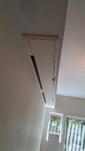 A newly installed custom wall enclosure or hidden compartment, showcasing handyman installation services by Fix Idaho LLC in Meridian, ID.