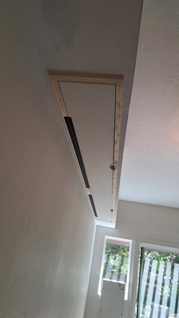 A newly installed custom wall enclosure or hidden compartment, showcasing handyman installation services by Fix Idaho LLC in Meridian, ID.