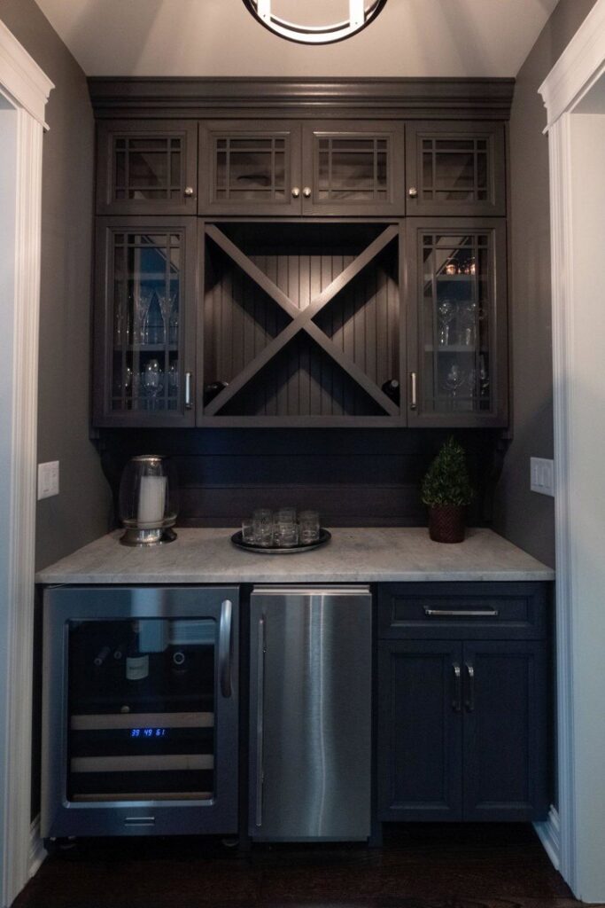 A custom built-in wet bar with dark cabinetry, a wine fridge, and a mini-fridge installed by FEARS Construction in Nashville, TN.