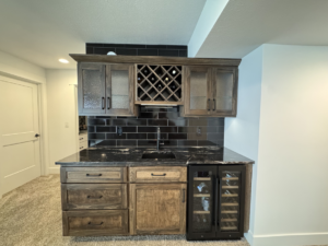 A completed custom wet bar installation with cabinetry, sink, and beverage cooler by McWilliams & Company in Ketchum, ID.