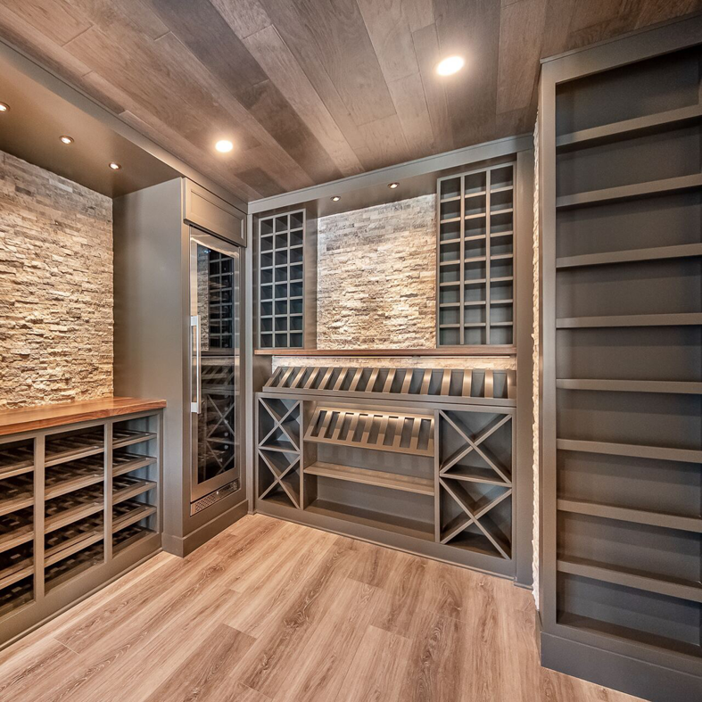 Custom wine cellar installation with stone walls and built-in shelving by BasementRemodeling.com in Rockville, MD.