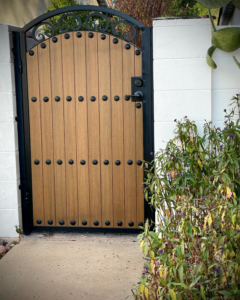 A custom wood and metal entry gate installed by Chavez Wrought Iron, LLC in Tucson, AZ