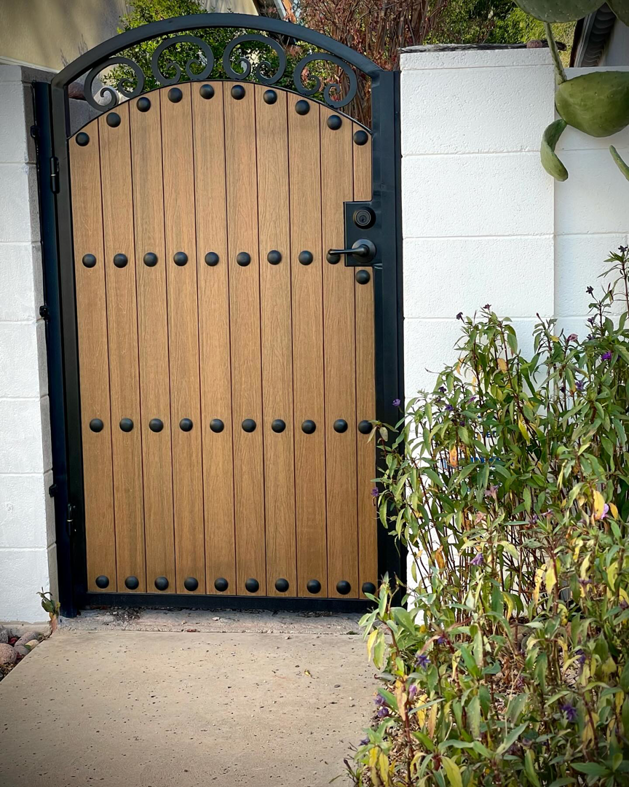 A custom wood and metal entry gate installed by Chavez Wrought Iron, LLC in Tucson, AZ