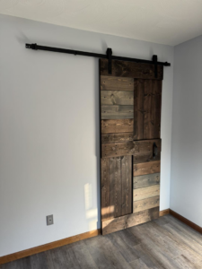 A custom wood barn door expertly installed by Strausbaugh Construction Services LLC in Cincinnati, OH.
