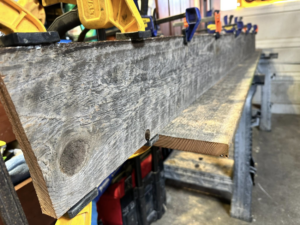 A custom wooden board securely clamped on sawhorses, ready for work by Valleys Finest Custom Finishes LLC in Salem, OR.