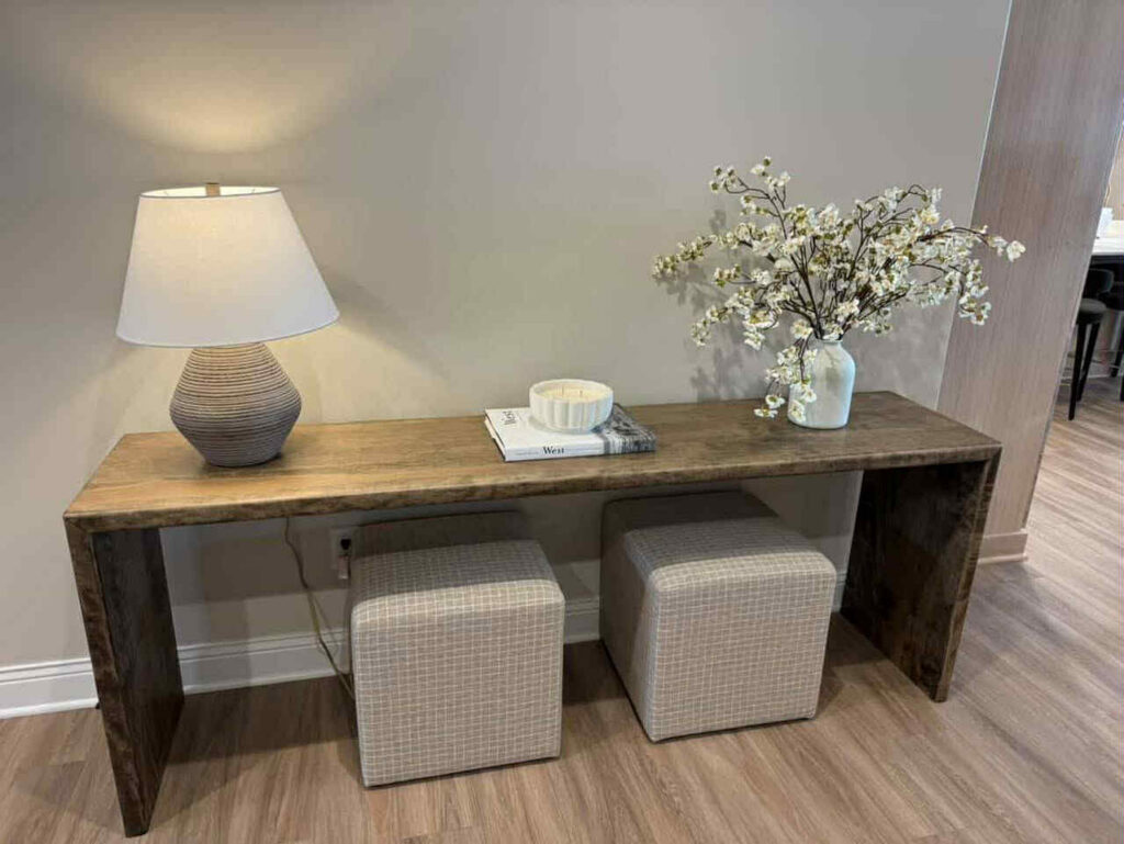 A custom-built wooden console table with two stools crafted by Renegade Woodworks in Kearney, NE.