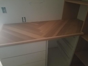 A newly installed custom wooden countertop with a herringbone pattern by Two Girls Cleaning Services in Brunswick, ME.