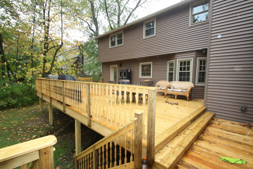 A large custom-built wooden deck with stairs by Four Seasons Building & Remodeling in Mauldin, SC.