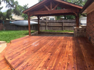 A custom-built wooden deck and pergola by Tin Star Fencing, enhancing an outdoor living space in Fort Worth, TX