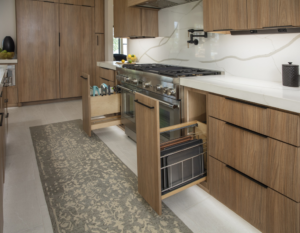 A modern kitchen featuring custom wooden cabinets and pull-out organizers installed by Preferred Millworks & Design in Edmond, OK.