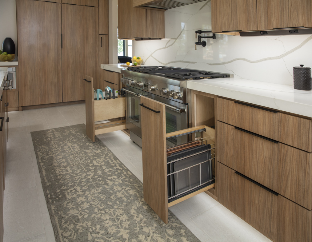 A modern kitchen featuring custom wooden cabinets and pull-out organizers installed by Preferred Millworks & Design in Edmond, OK.