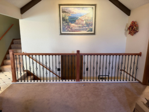 A newly installed custom wood and metal stair railing by Blackbird Custom Carpentry in Kansas City, MO.