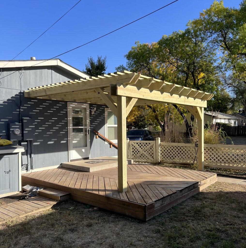 A custom-built wood pergola over a wooden deck by Smitty's Handyman Service LLC in Mesquite, TX.