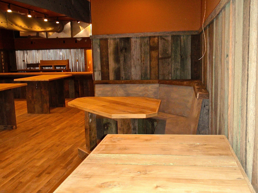 Custom wooden tables, benches, and wall paneling installed by Triad Construction Company LLC in Ashland City, TN.