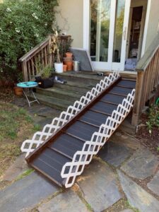 A custom-built wooden accessibility ramp with white lattice railings, installed by Dan's Home and Yard in Oakland, CA.